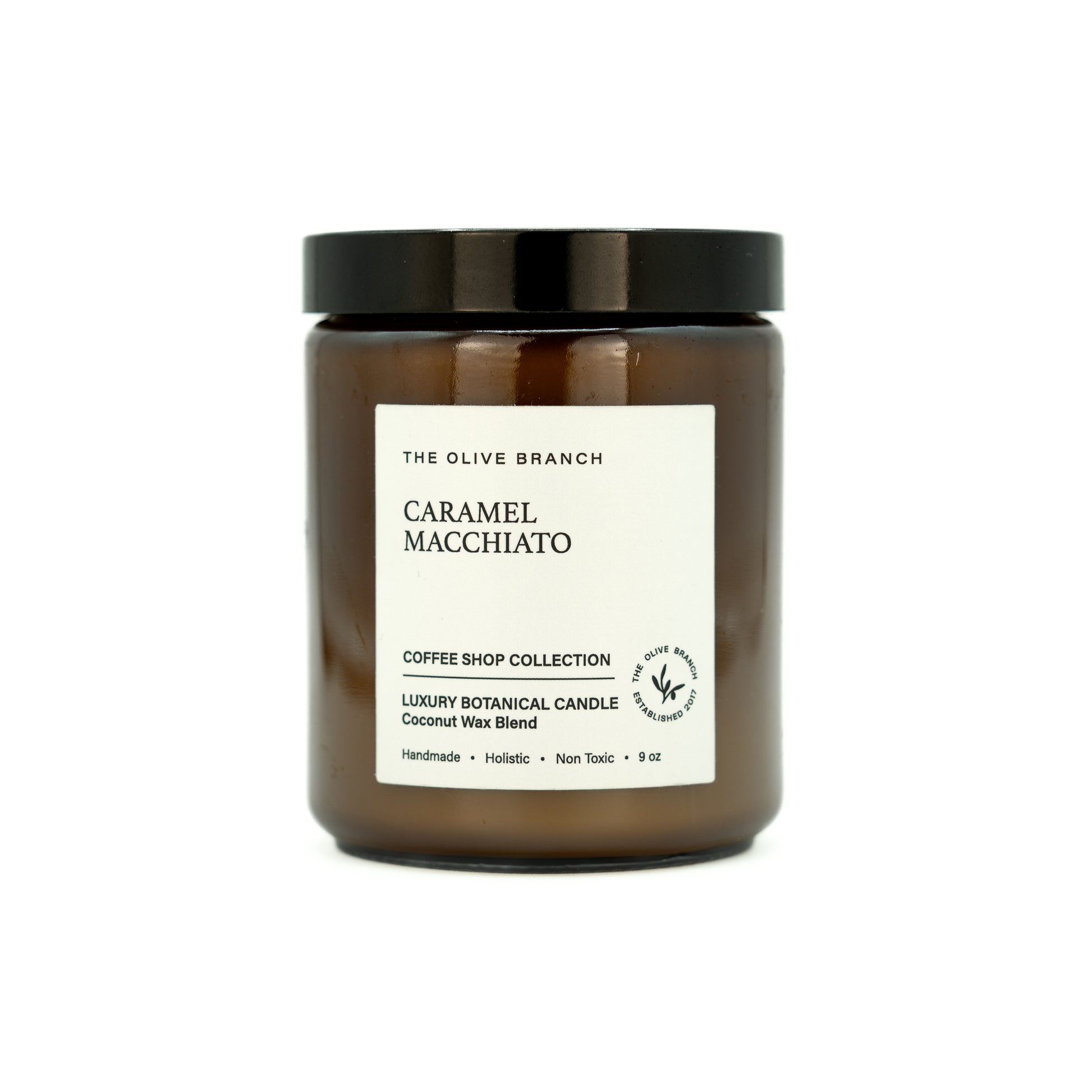 Candle jar labeled 'Caramel Macchiato' from 'The Olive Branch' on a white background