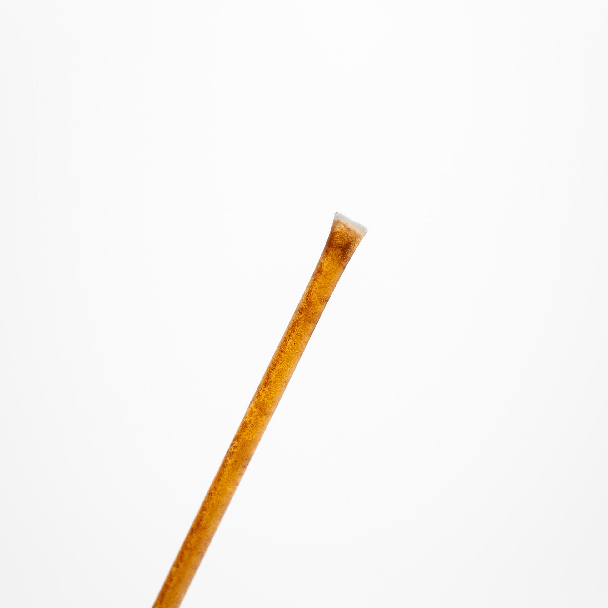 Raw honey stick on a white background.