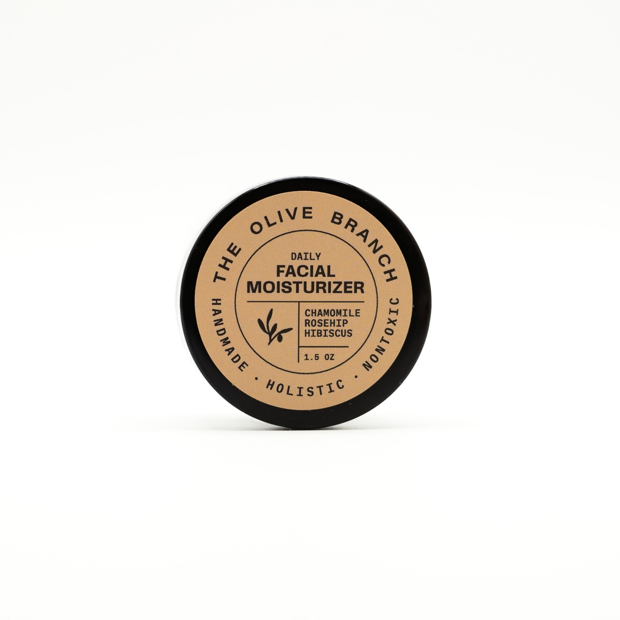 Facial moisturizer container with 'The Olive Branch' branding on a white background