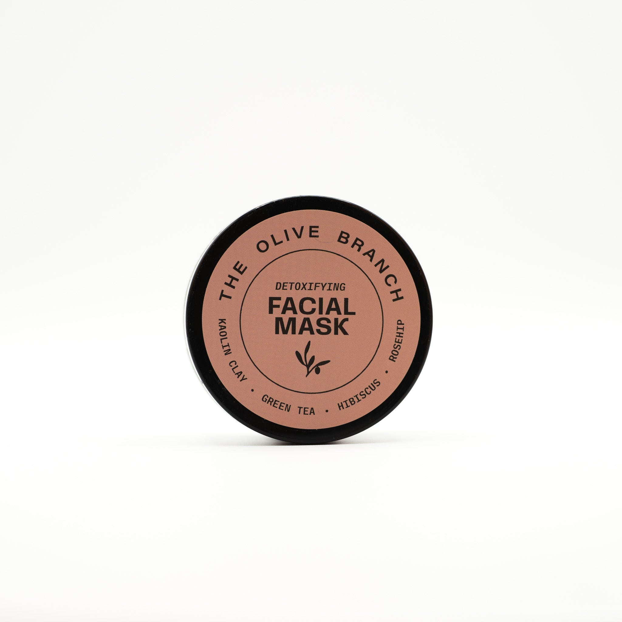 Facial mask container with 'The Olive Branch' branding on a white background