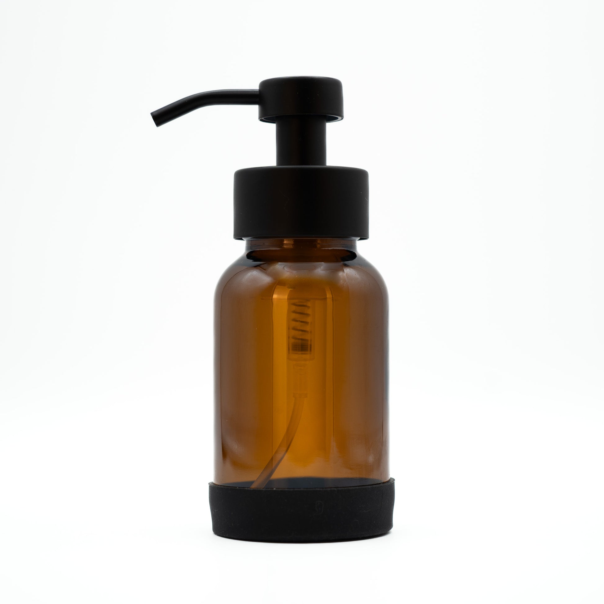 Amber glass bottle with black pump on a white background
