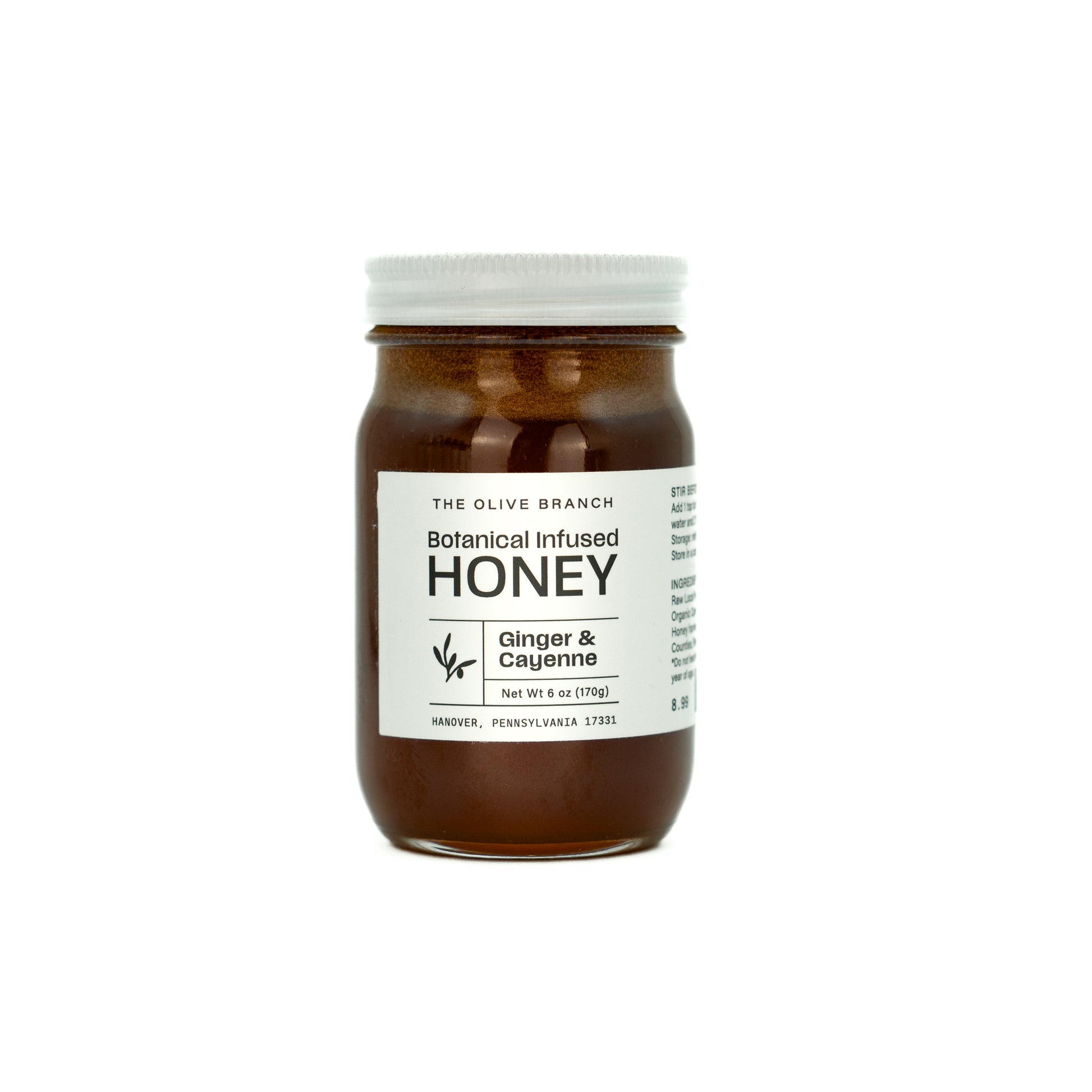 Jar of botanical infused honey with a label on a white background