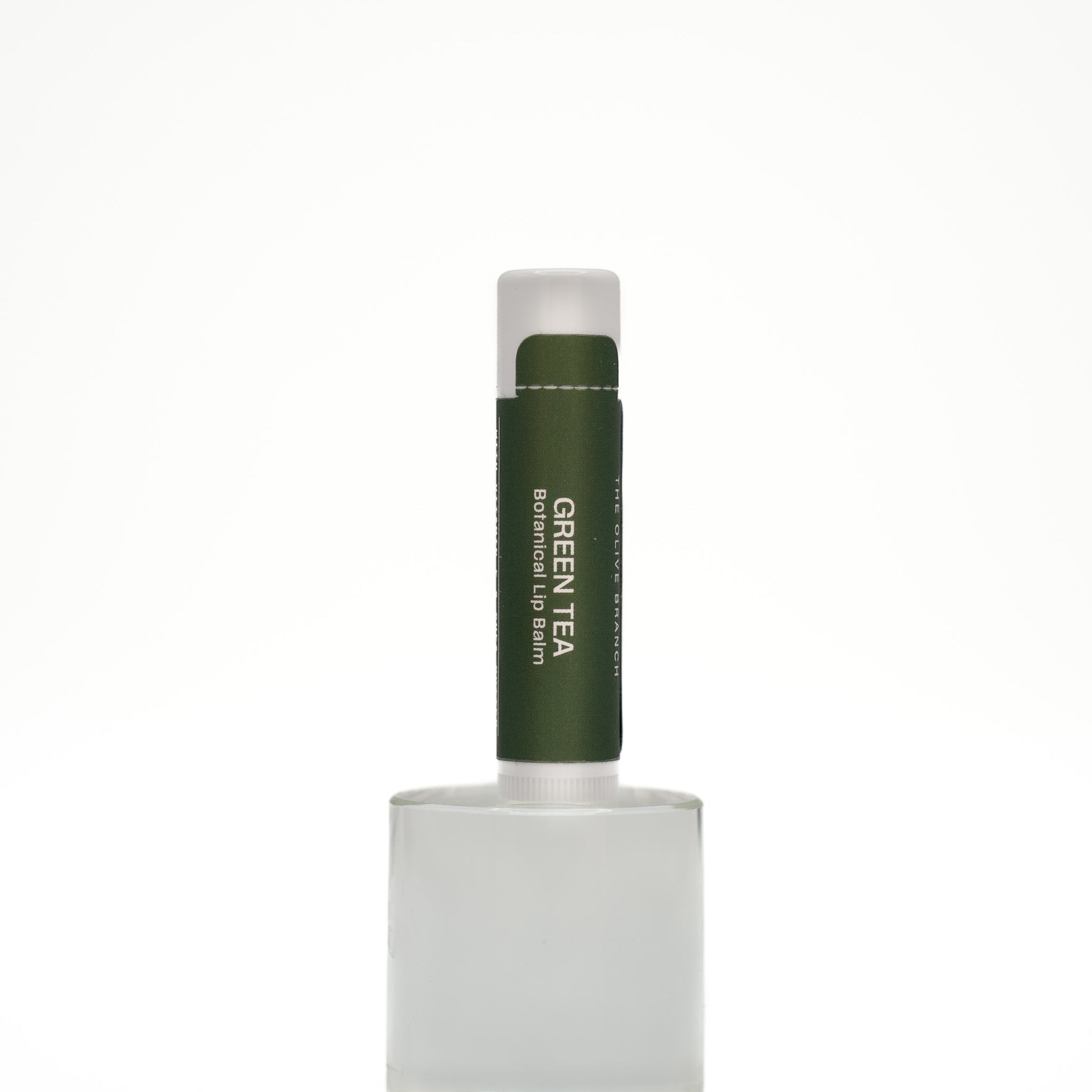 Green tea lip balm on a white background