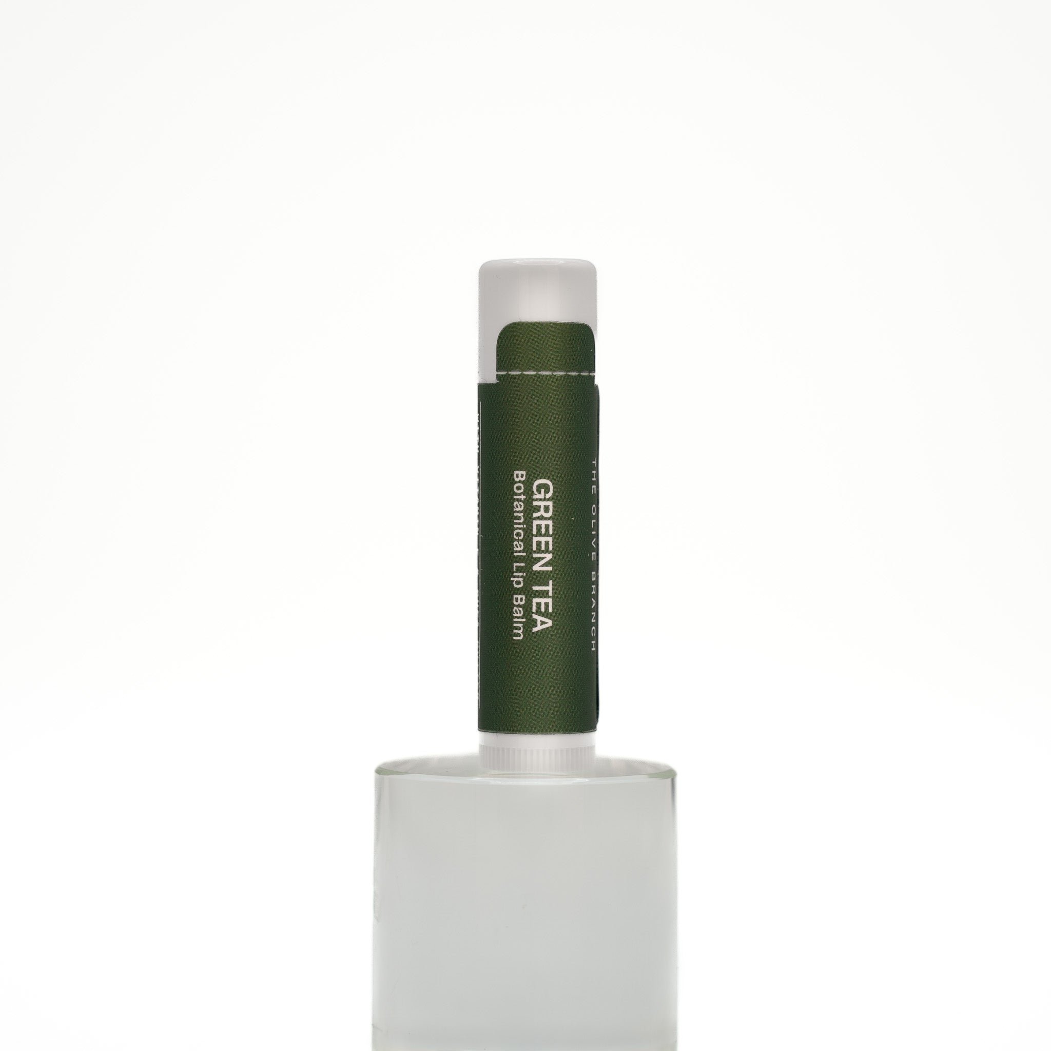 Green tea lip balm on a white background