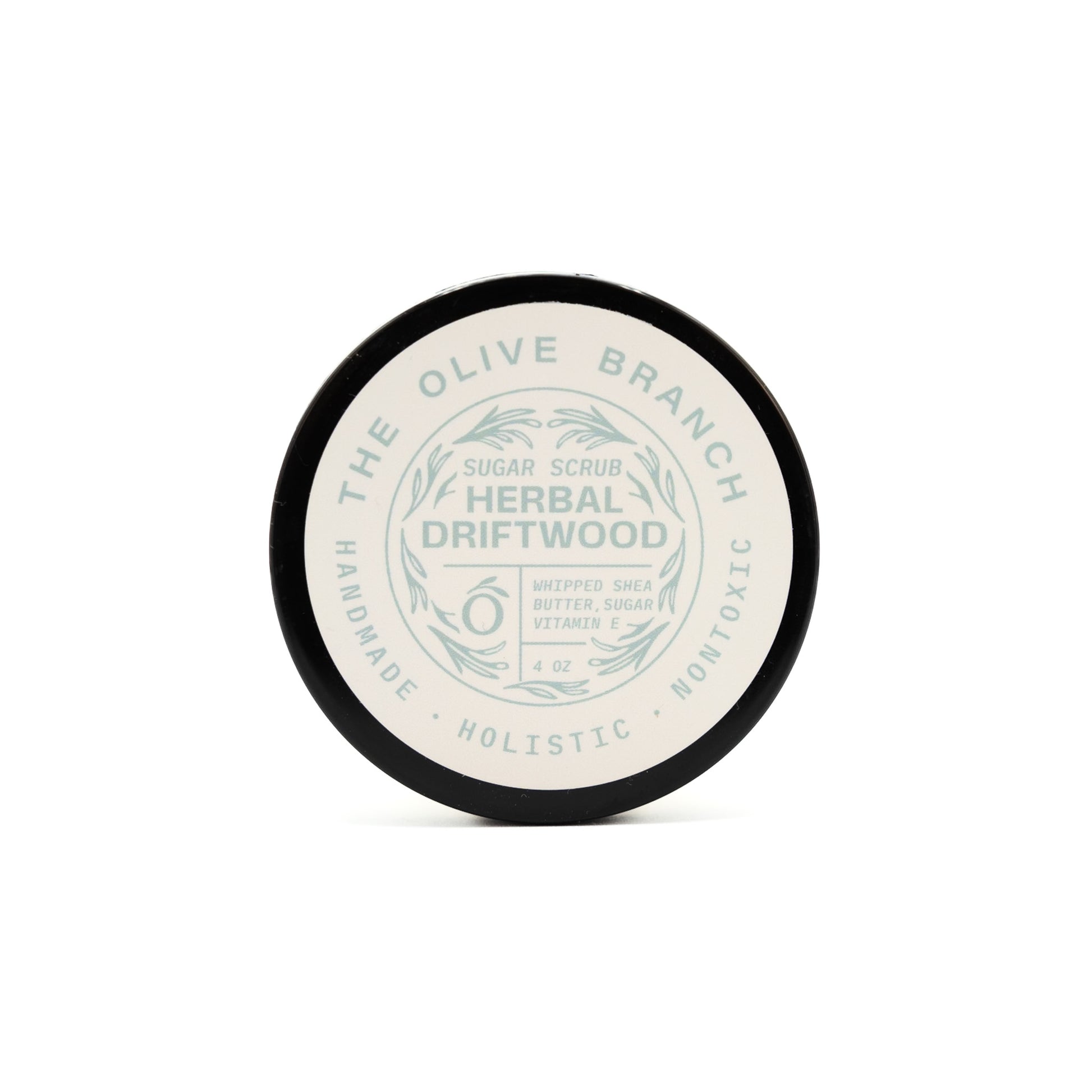 Jar of herbal driftwood sugar scrub with 'The Olive Branch' branding on a white background