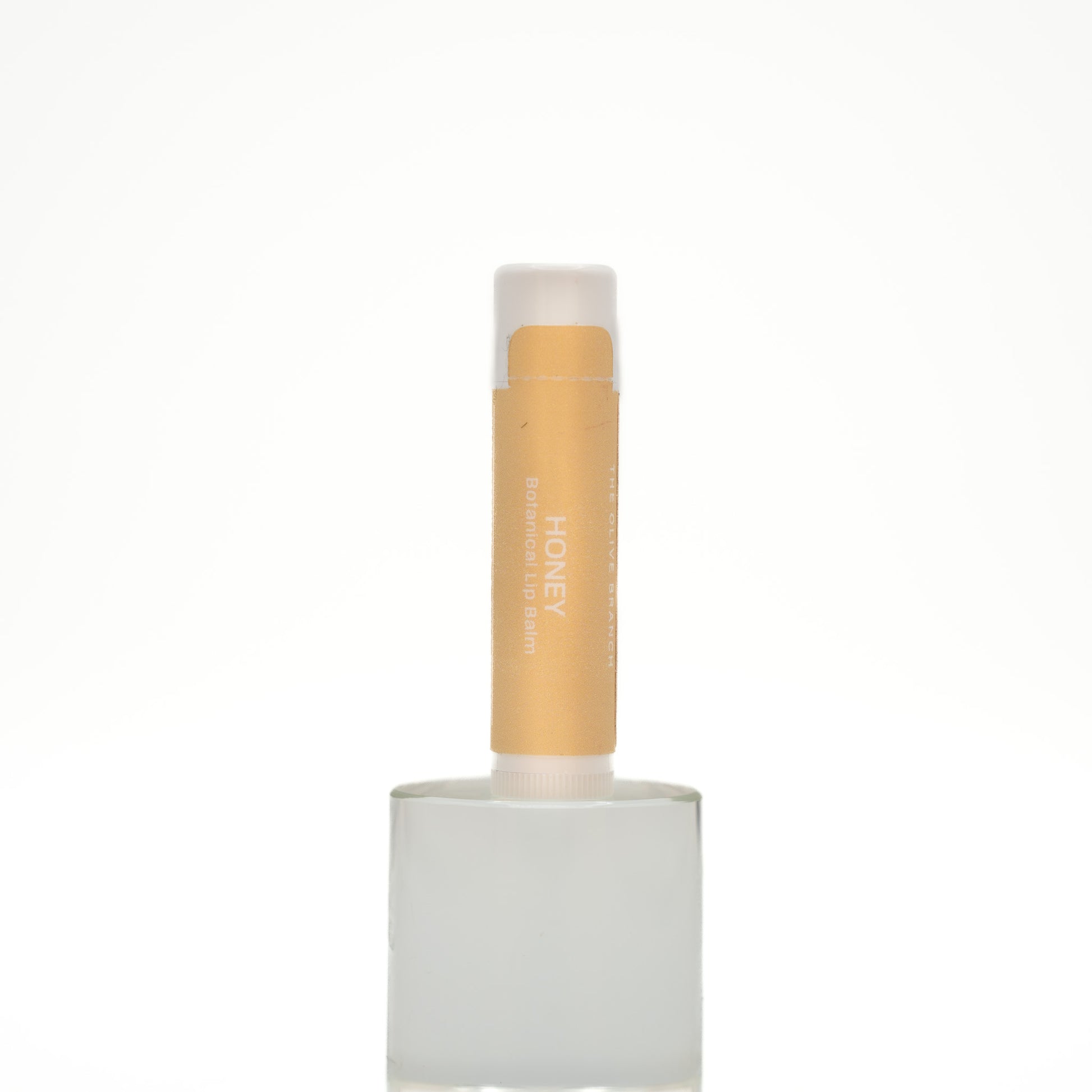 Lip balm with a white cap and visible brand name on a white background