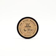 Eye cream container labeled 'The Olive Branch' on a white background
