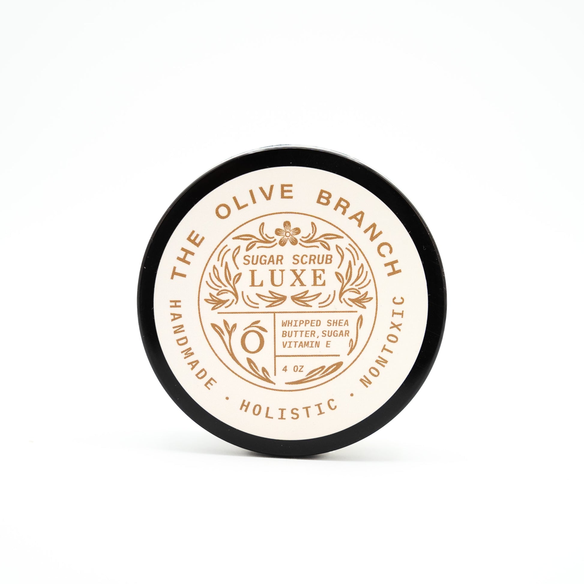 Round container of The Olive Branch Sugar Scrub Luxe on a white background