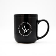 Black mug with 'The Olive Branch Made with Love' logo on a white background