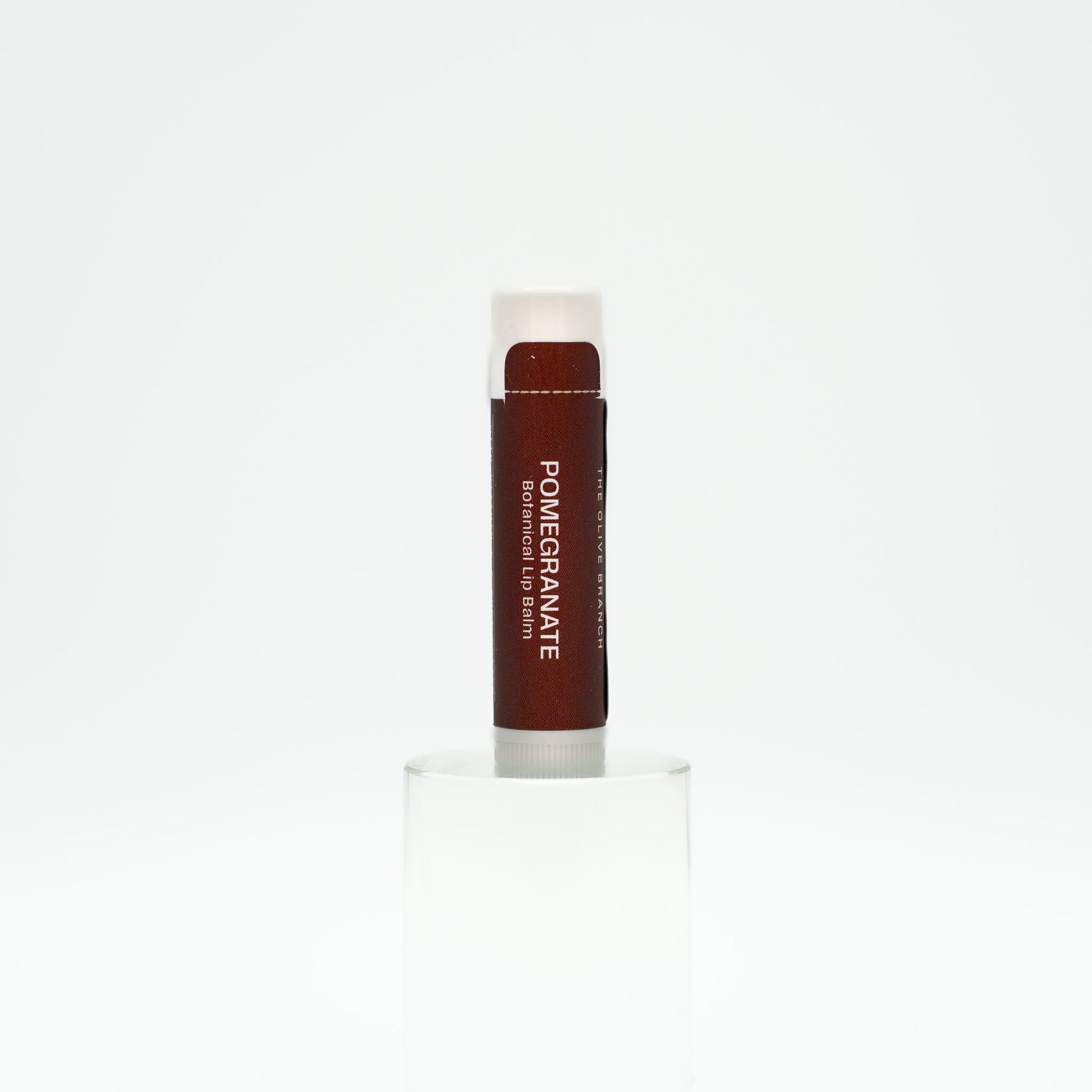 Lip balm with 'Pomegranate' flavor on a white background