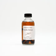 Bottle of vanilla extract with a label on a white background