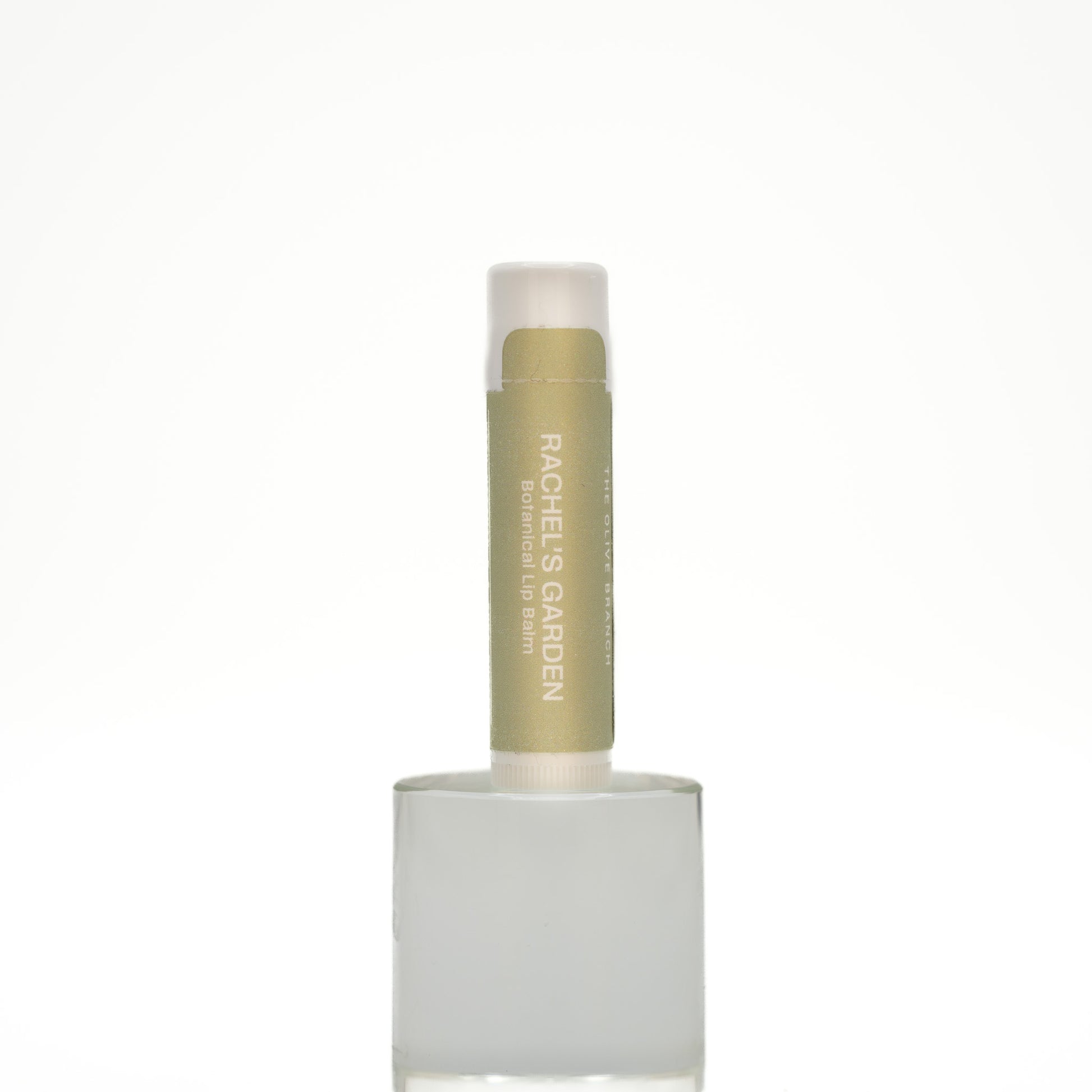Lip balm with white cap and green body on a white background