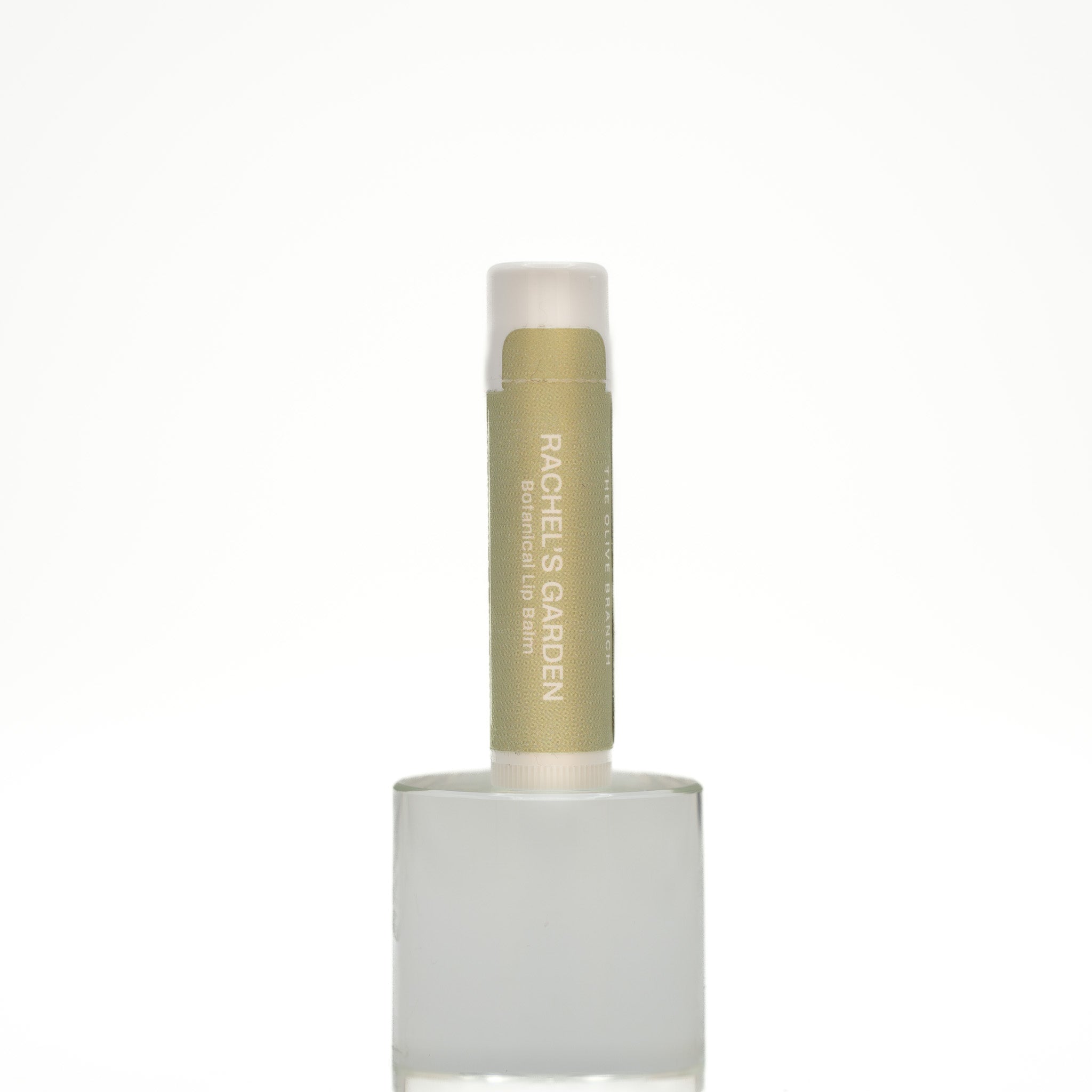Lip balm with white cap and green body on a white background