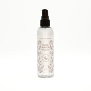 Rose water spray bottle with branding on a white background