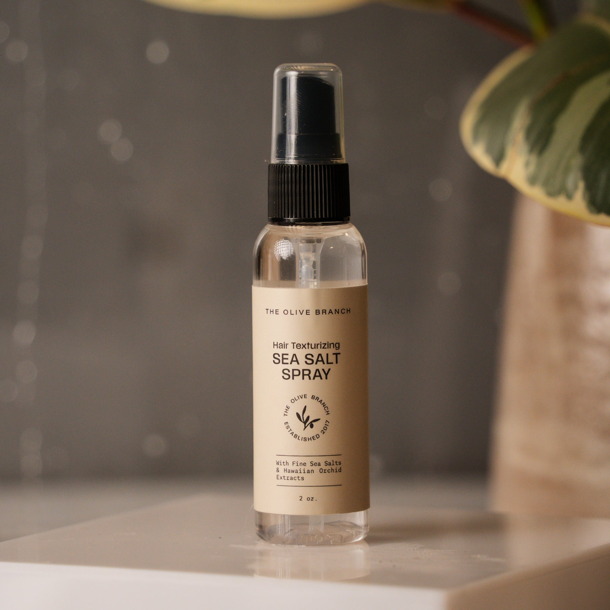Hair texturizing sea salt spray bottle on a neutral background
